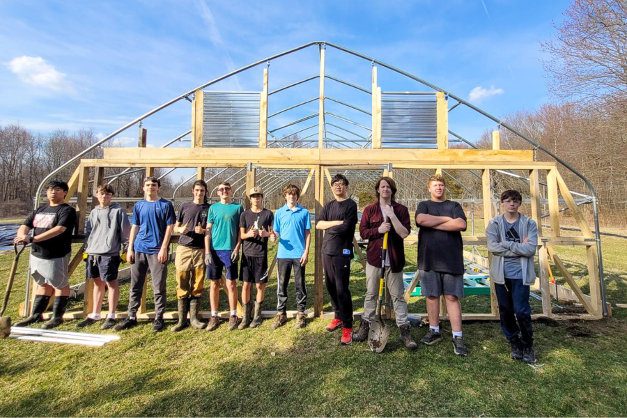 The Trinity-Pawling farming team in front of the new greenhouse